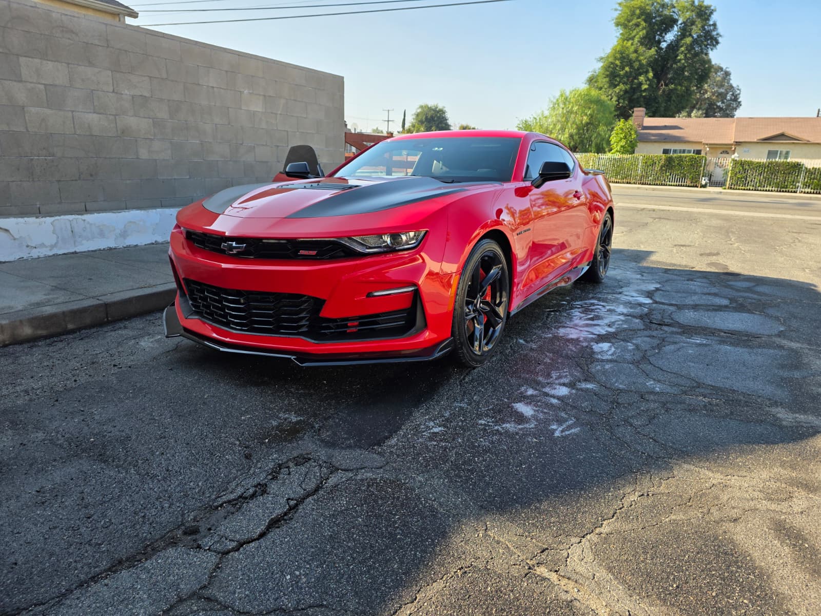 Freshly washed red Chevrolet Camaro at a customer location