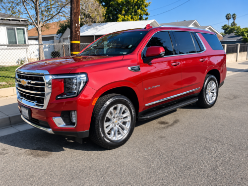 Candy-Apple Red Chevrolet Suburban on a Sunny Suburban Street