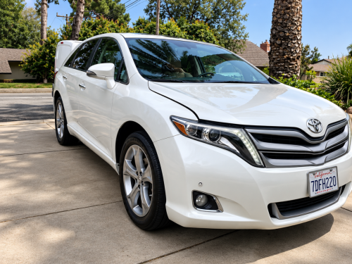 White Toyota on a Sunny Suburban Driveway